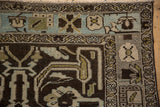 Distressed vintage Mehriban rug corner, displaying dusty blue border and floral motifs.