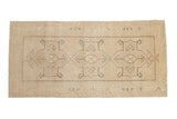 Vintage distressed Oushak runner in light beige with faded gray geometric patterns.