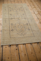 Distressed pile and geometric pattern detail of a vintage Oushak rug runner.