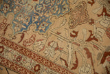 Distressed pile of an antique Karabagh runner showcasing blue germinating plant motifs and a red border.