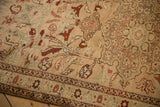 Distressed antique Karabagh rug with short pile, soft apricot, burgundy, and slate blue botanical motifs.
