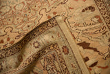 Folded corner of antique Karabagh rug, showing hand-knotted back and distressed apricot beige pile.