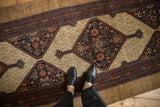 Antique Serab runner with diamond medallion, Herati motif, and wide camel ground border.