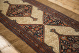Antique Serab runner showing detailed diamond medallions with Herati motif on camel ground.