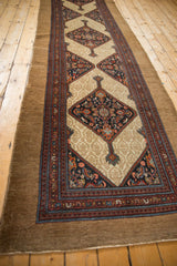 Serab antique runner's wide natural camel border and a diamond medallion with Herati floral motif.