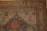 Malayer rug corner showcasing distressed blue-green field and cherry red serpent vine border.
