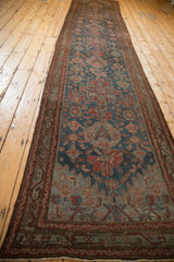 Distressed Persian Malayer runner, cherry red serpent vine border, dusty blue floral motifs.