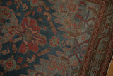 Distressed vintage Malayer runner showing worn pile, exposed foundation, and faded red and blue patterns.