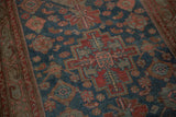 Distressed Malayer rug pile showing mostly even wear and dusty blue, cherry red motifs.
