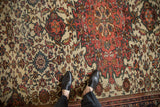 Hand-knotted detail of floral top views and serrated leaves on an antique Persian Farahan Sarouk.