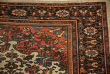 Intricate corner construction of an antique Farahan Sarouk carpet with floral motifs and even, low pile.