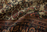 Detailed view of an antique Persian carpet showing the low pile, visible knot heads, and floral pattern.