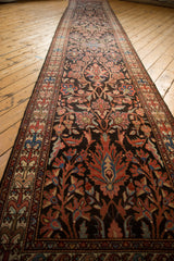 Lengthwise perspective of a vintage Malayer runner's intricate floral and vine pattern.
