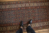 Overhead view of an antique Persian Malayer runner's intricate, low-pile traditional design.