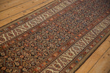 Long perspective of an antique Malayer runner's field showing a complex serrated leaf trellis.