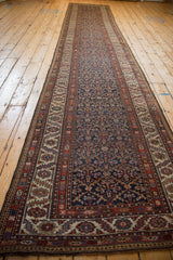 Overhead view down the length of an antique Malayer runner, showing its complex geometric field.