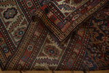 Folded corner of an antique Malayer runner reveals its intricate hand-knotted borders and textured pile.