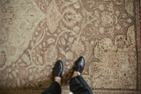 Distressed texture on a vintage Kayseri rug with sprawling vines in beige and dusty rose.