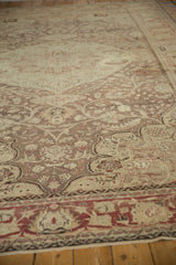 Angled view of the worn pile and intricate floral design on a vintage Kayseri carpet.