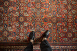Detailed Herati motif on a vintage Mahal carpet showing the low pile in brick red and blue tones.