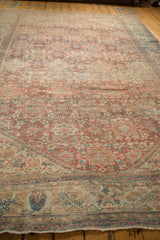 Worn texture and pale ruby red, sapphire blue motifs on a vintage distressed Mahal carpet.