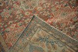 Folded corner of Mahal carpet, revealing machine-bound edge, worn pile, and patterned foundation.