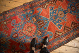 Interconnected turtle style medallions in sapphire blue and madder red along an antique Persian Heriz runner.