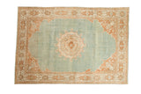 Vintage distressed Persian Meshed carpet with a roundel medallion in terracotta on an abrashed powder blue field.