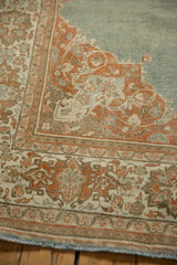 Detail of the intact side cord selvage on a distressed Persian rug with terracotta borders.