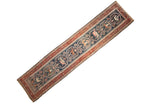 Antique Persian Malayer runner with pictorial medallions of a hunting scene on a dark teal and red field.