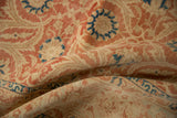 Low pile of a distressed Kashan carpet showing wear to knot heads and faded red arabesques.