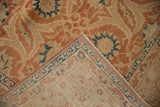 Folded corner of a vintage Kashan rug showing the low pile front and tightly woven hand-knotted back.