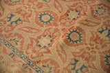 Close-up showing the worn texture of a distressed Kashan carpet with red and blue arabesques.