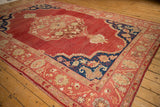Vintage Oushak carpet's detailed outer border with beige, ivory, and red floral motifs.