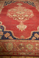 Vintage Oushak rug with a cobalt blue corner spandrel and red abrashed field.