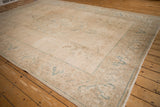 Distressed texture and faded seafoam blue scrolled patterns on a vintage Tabriz carpet.