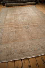 Distressed Tabriz rug's worn beige edge showing foundation knot heads and short fringe.