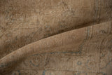 Textured surface of vintage distressed Tabriz carpet, revealing foundation and knot heads.