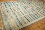 Angled view of the long shaggy pile with striped blue, rose, and ivory columns.