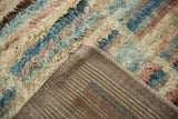 The striped hand-knotted back and long shaggy pile of an Afghani Moroccan design carpet.