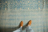 Pale turquoise and cream textured geometric and chevron patterns on a modern Afghani rug.