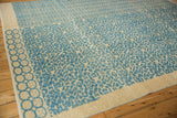 Afghani modern rug's three-dimensional blue geometric, chevron, and roundel patterns.