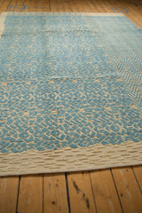 Textured geometric design and mixed weave of an Afghani modern rug in blue and cream.