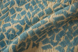 Three-dimensional pale turquoise pile against cream flat weave, modern geometric.