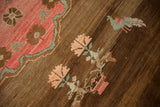 Love bird and floral motifs on heavily abrashed chocolate brown field of vintage Oushak.