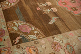 Decorative abrashed chocolate Oushak field with pink blossoms and a mint love bird.