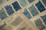 Afghani modern rug's textured blue and ivory geometric pile, revealing its flat woven back.