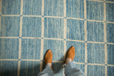 Modern Afghani carpet's striated powder blue, ivory geometric grid pattern with heavy abrashes.