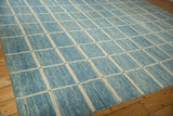 Afghani Modern geometric carpet showing ivory grid lines on striated powder and sky blue field.