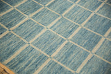 Afghani carpet: Modern geometric ivory grid with striated powder to sky blue.
